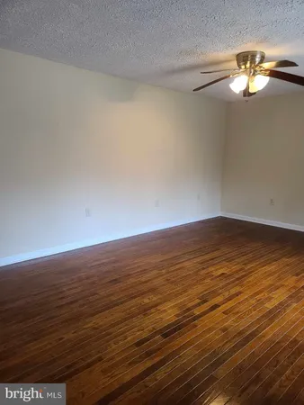 a view of an ocean an empty room and wooden floor