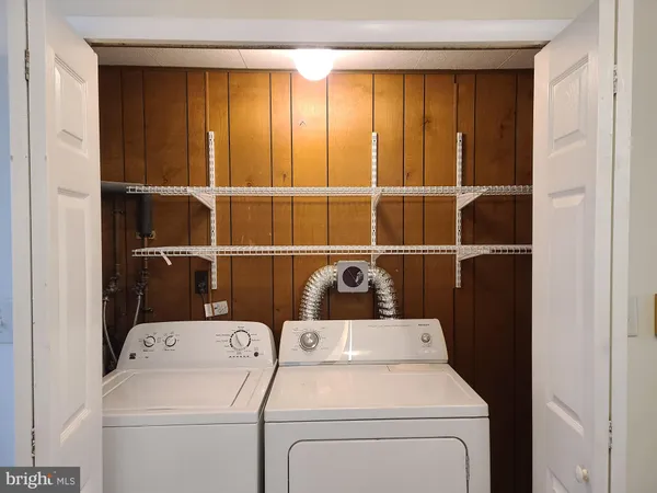 a view of storage and utility room with washer and dryer