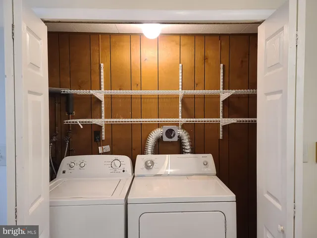 a view of storage and utility room with washer and dryer
