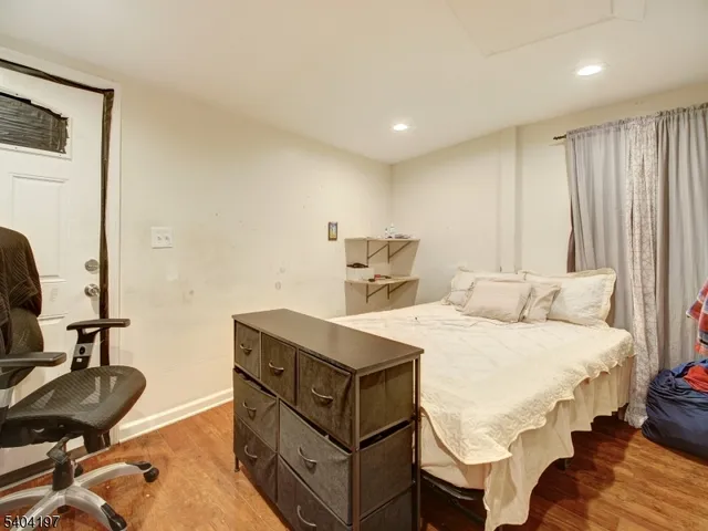 a bedroom with a bed and a chair