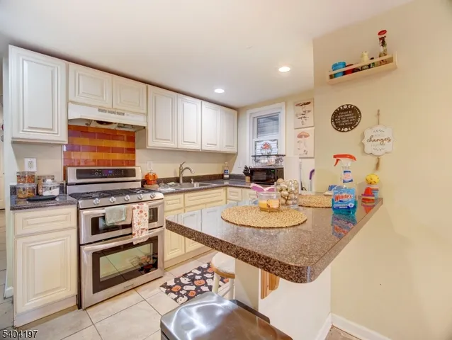 a kitchen with stainless steel appliances granite countertop a sink and cabinets