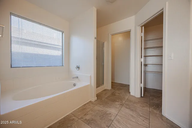 a bathroom with a bathtub and a shower