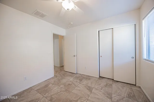 an empty room with a ceiling fan