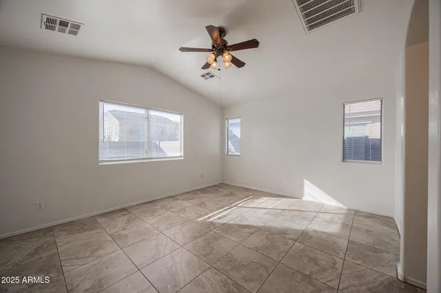 a view of an empty room with a ceiling fan