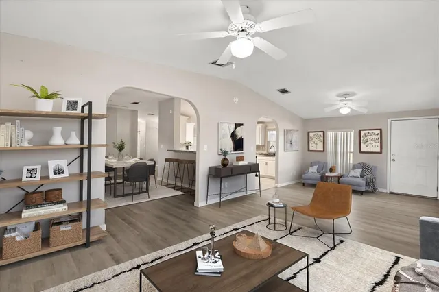 a living room with furniture and wooden floor