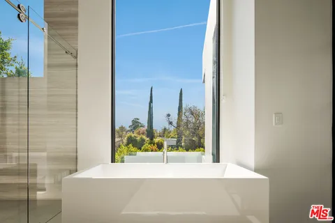 a view of a chairs and table in the balcony