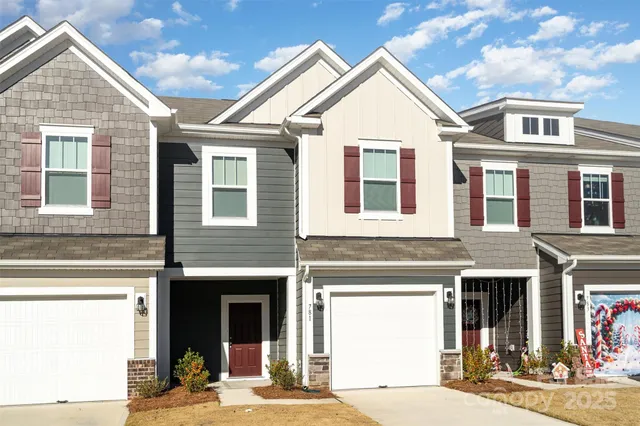 a view of a brick house with many windows