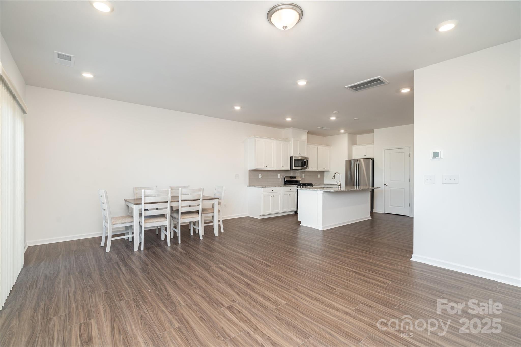 781 Earhart Street Northwest Concord, NC 28027 - Photo 14 of 31 a kitchen with a table and chairs