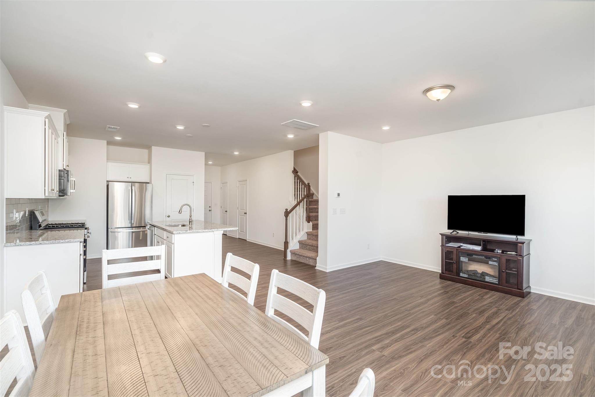 781 Earhart Street Northwest Concord, NC 28027 - Photo 15 of 31 a living room with furniture and a flat screen tv
