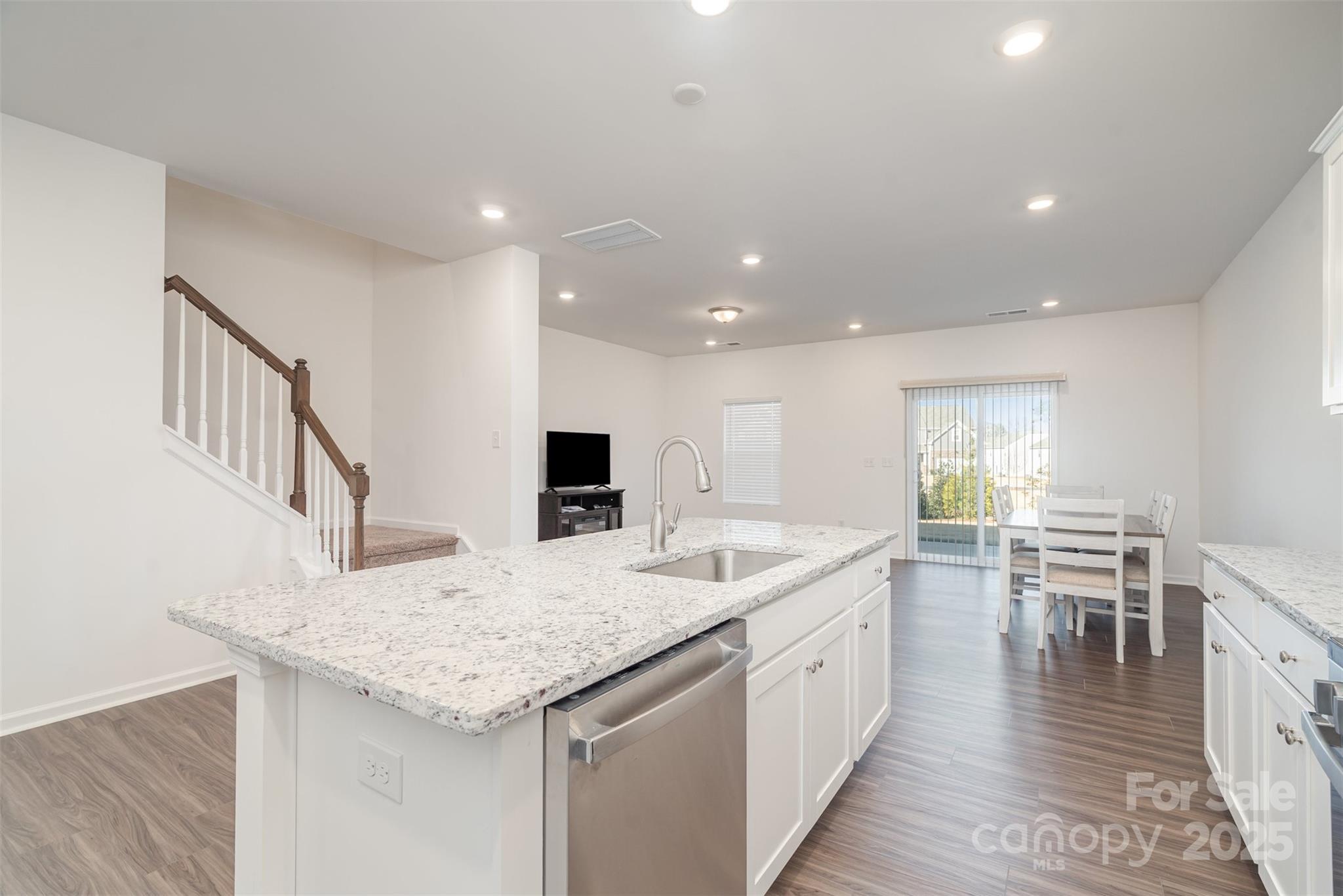 781 Earhart Street Northwest Concord, NC 28027 - Photo 18 of 31 a kitchen with a sink and chairs