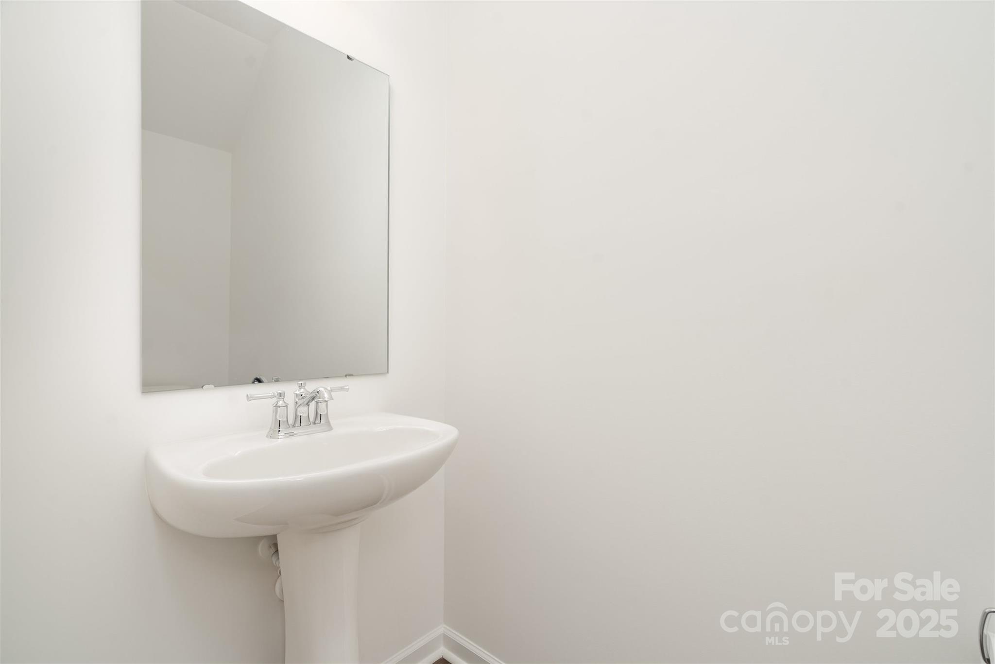 781 Earhart Street Northwest Concord, NC 28027 - Photo 19 of 31 a bathroom with a sink and a mirror