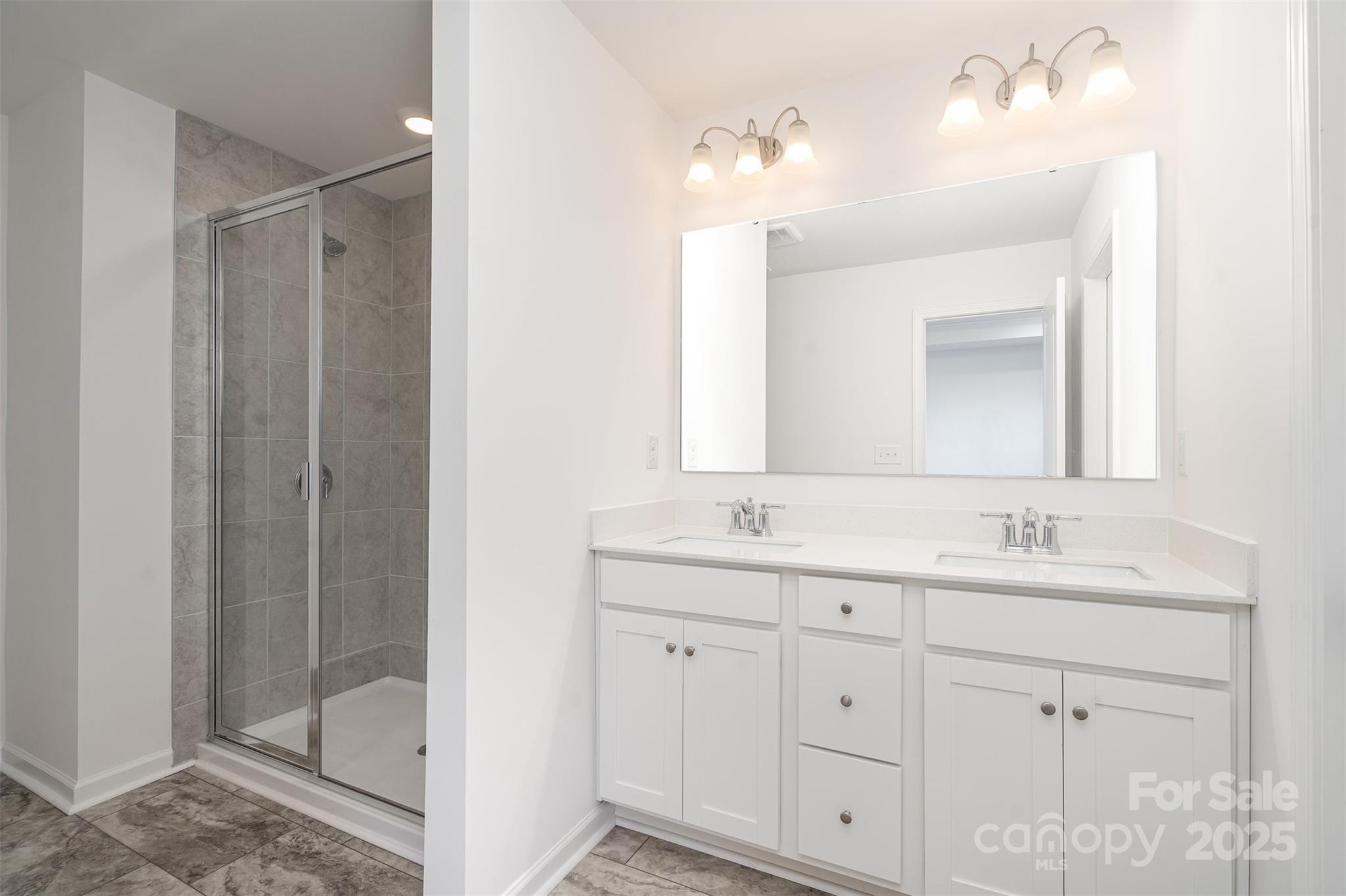 781 Earhart Street Northwest Concord, NC 28027 - Photo 5 of 31 a bathroom with a double vanity sink and mirror