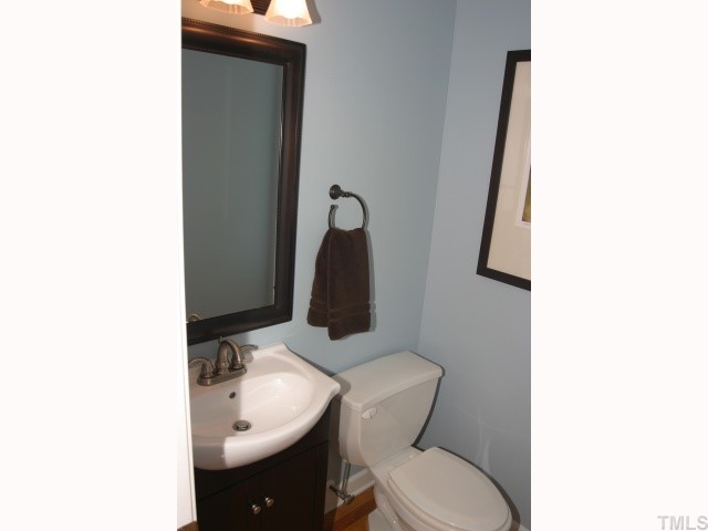 10013 Kilnstone Lane Raleigh, NC 27613 - Photo 11 of 12 a bathroom with a toilet sink and mirror