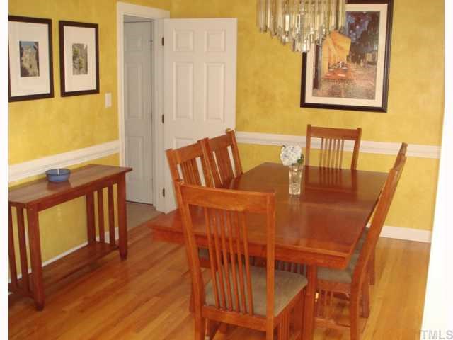 10013 Kilnstone Lane Raleigh, NC 27613 - Photo 5 of 12 a view of a dining room with furniture and wooden floor