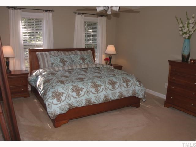 10013 Kilnstone Lane Raleigh, NC 27613 - Photo 6 of 12 a bedroom with a bed and window