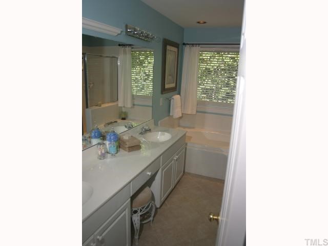 10013 Kilnstone Lane Raleigh, NC 27613 - Photo 7 of 12 a bathroom with a sink and a mirror