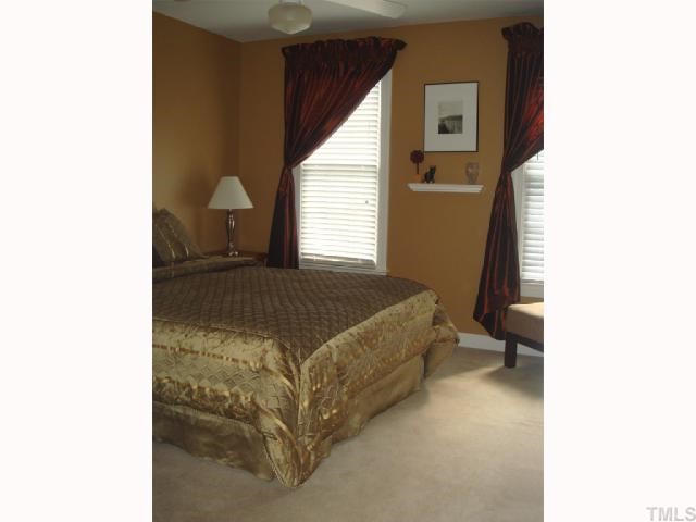 10013 Kilnstone Lane Raleigh, NC 27613 - Photo 9 of 12 a bedroom with a bed and a window