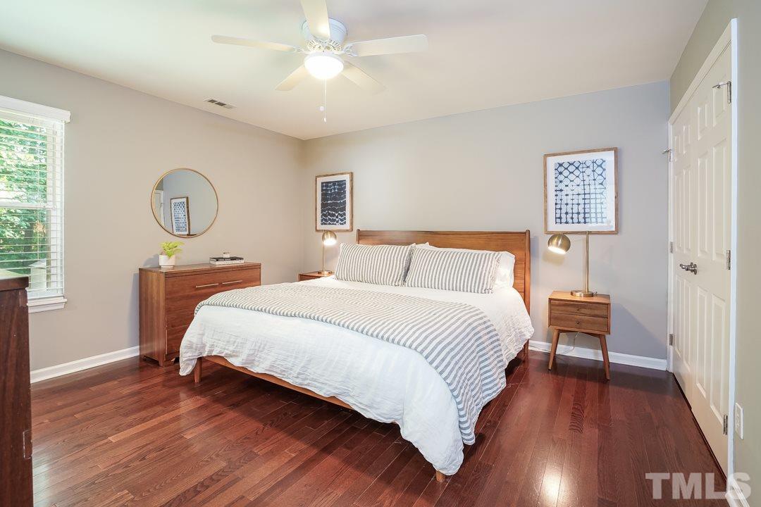 2433 Village Grove Road Raleigh, NC 27613 - Photo 13 of 24 a bedroom with a bed and a table