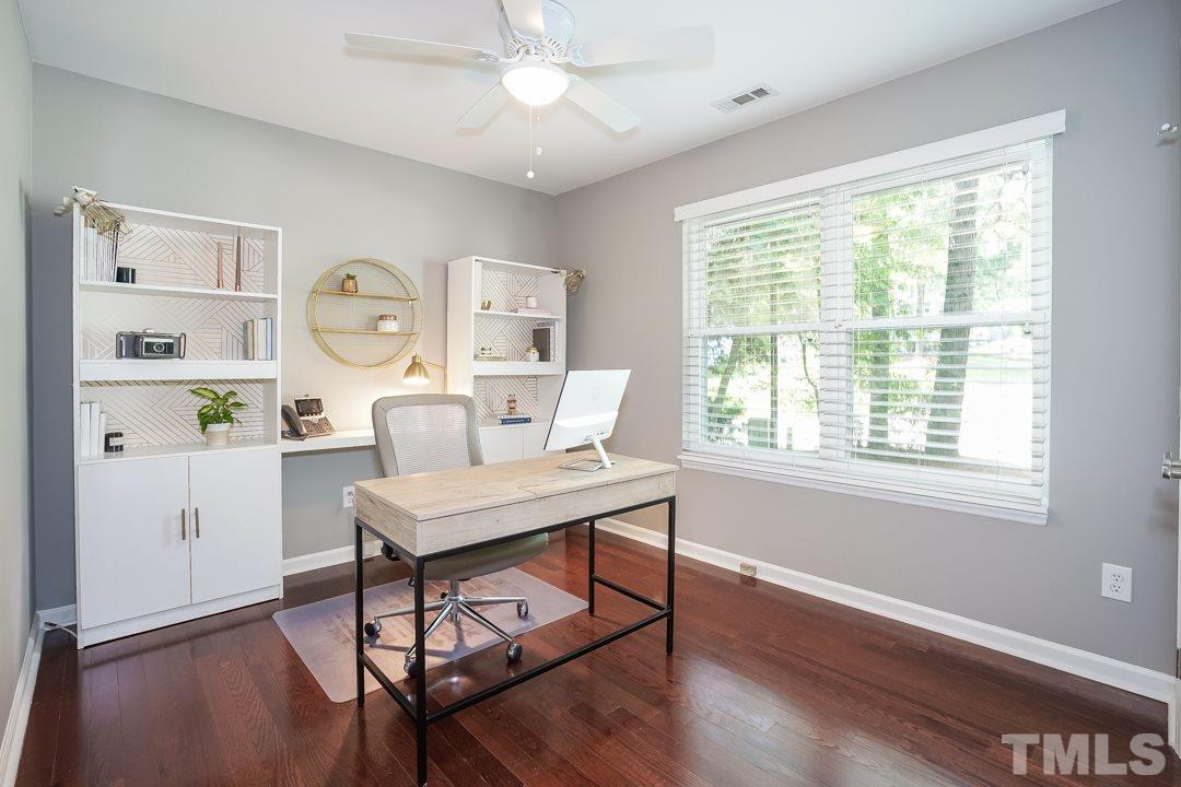 2433 Village Grove Road Raleigh, NC 27613 - Photo 16 of 24 a view of a workspace with furniture and a window