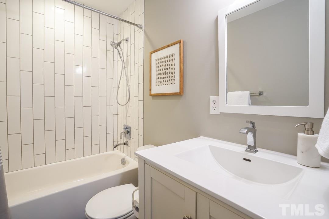 2433 Village Grove Road Raleigh, NC 27613 - Photo 17 of 24 a bathroom with a sink toilet and bathtub