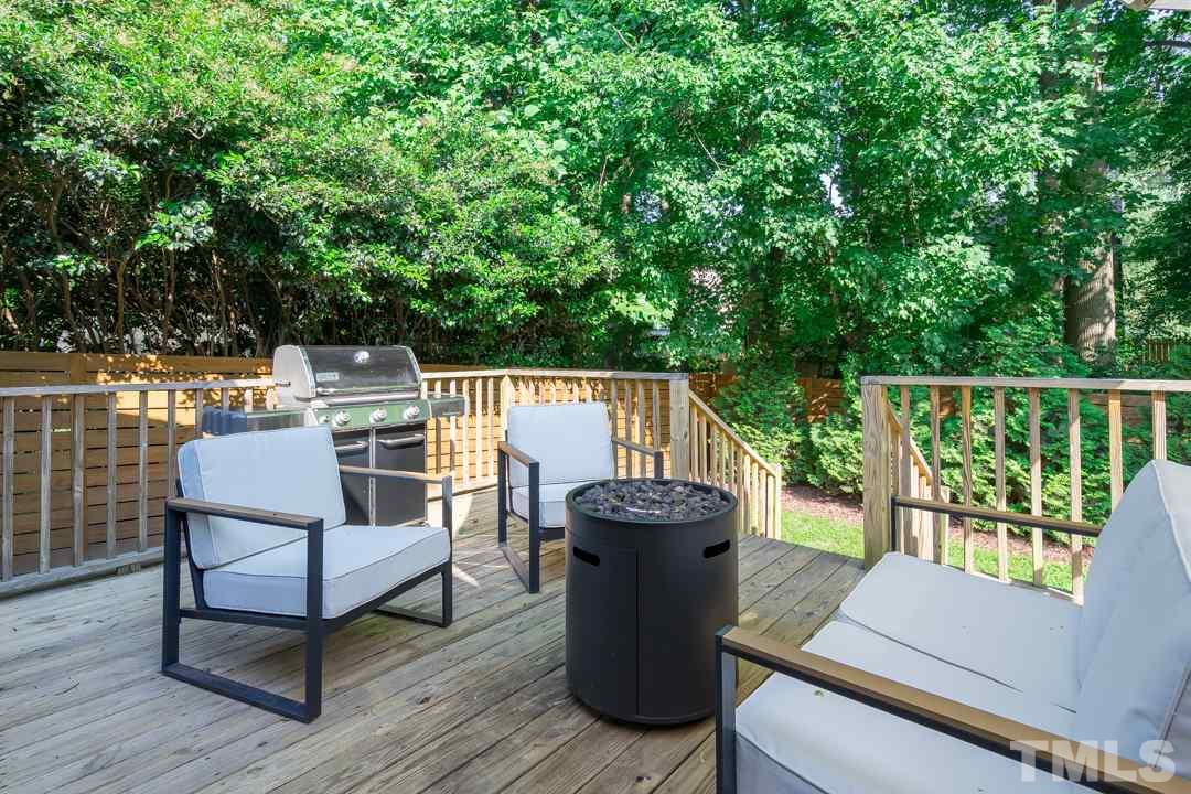 2433 Village Grove Road Raleigh, NC 27613 - Photo 22 of 24 a view of a chairs and table on the wooden deck