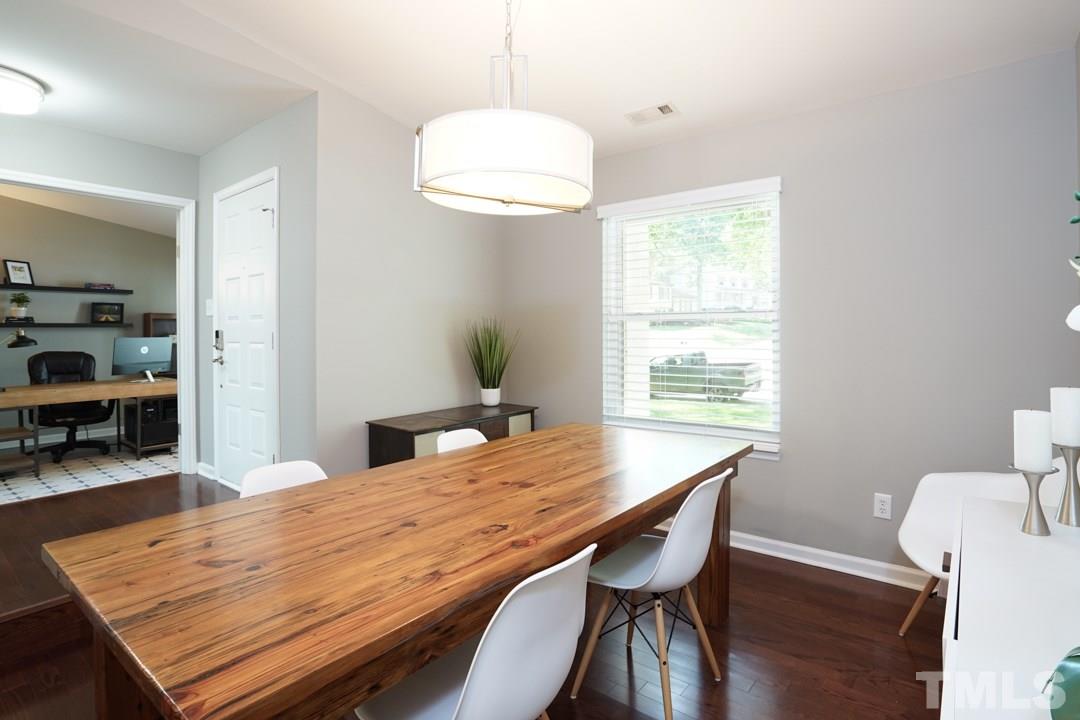 2433 Village Grove Road Raleigh, NC 27613 - Photo 4 of 24 a dining room with a table and chairs