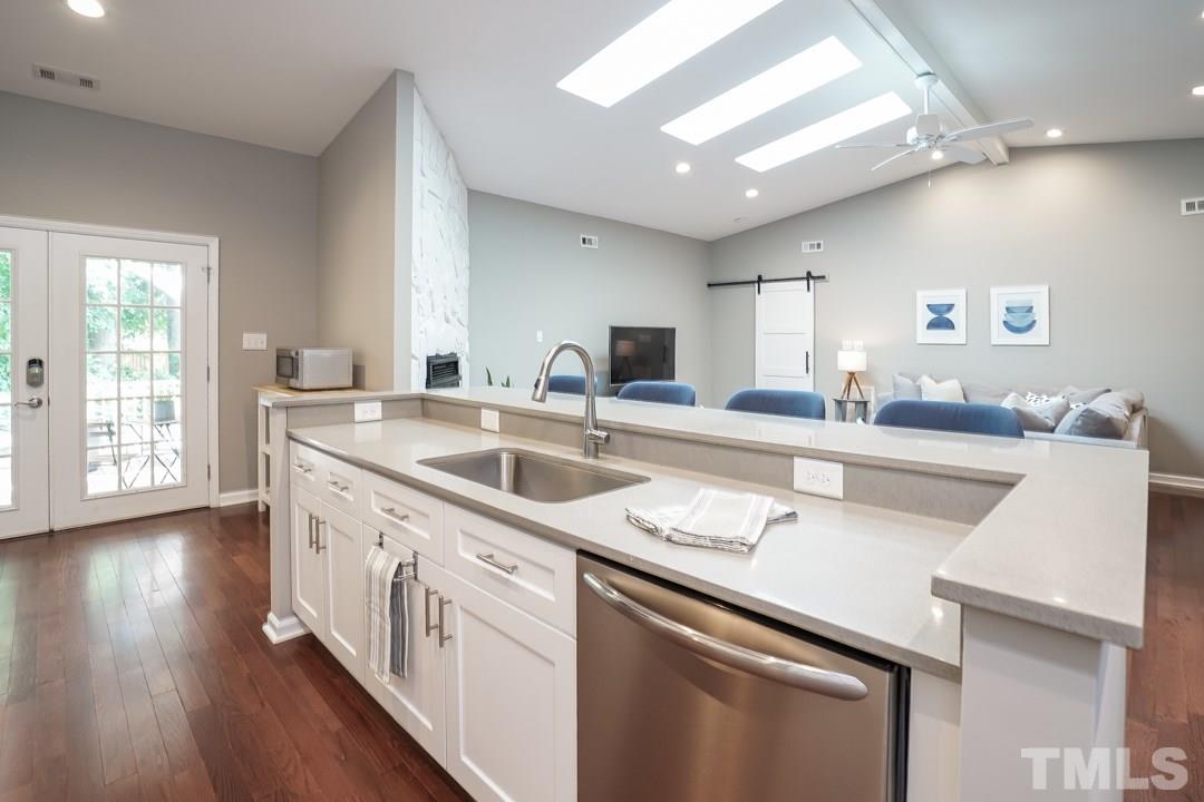 2433 Village Grove Road Raleigh, NC 27613 - Photo 6 of 24 a kitchen with a sink stove and cabinets