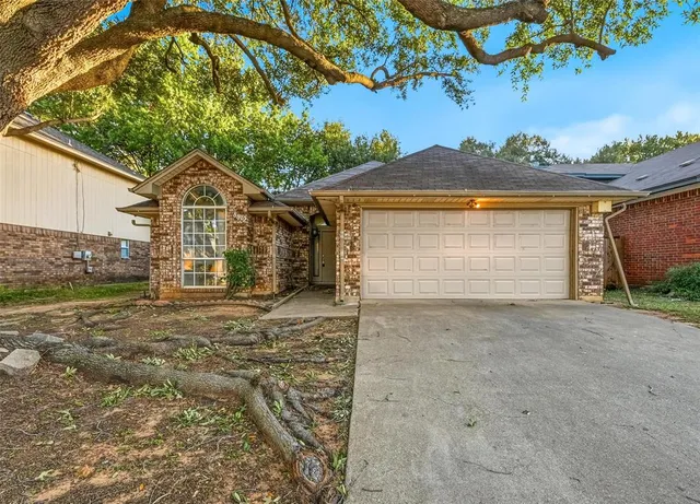 a view of a house with a yard and garage