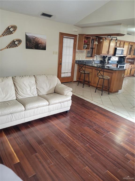 402 Jupiter Street Mission, TX 78572 - Photo 13 of 27 a living room with furniture and wooden floor