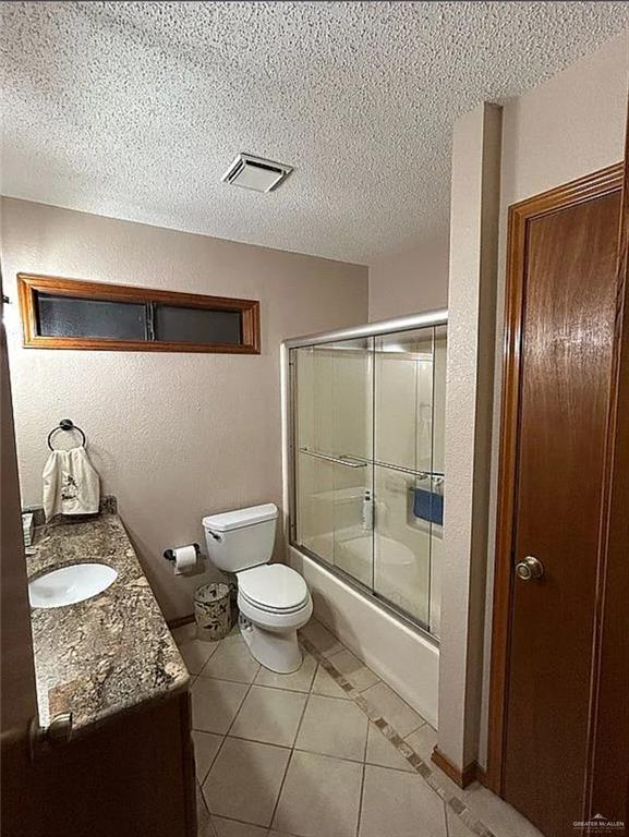 402 Jupiter Street Mission, TX 78572 - Photo 14 of 27 a bathroom with a granite countertop sink toilet and shower