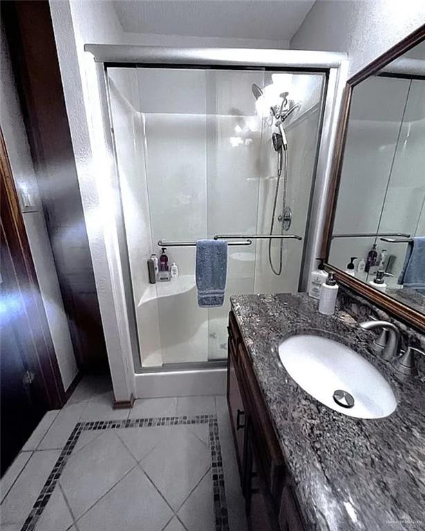 402 Jupiter Street Mission, TX 78572 - Photo 16 of 27 a bathroom with a sink a mirror and a shower