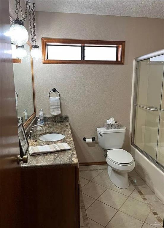 402 Jupiter Street Mission, TX 78572 - Photo 17 of 27 a bathroom with a granite countertop sink toilet and a mirror