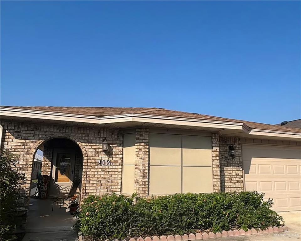 402 Jupiter Street Mission, TX 78572 - Photo 2 of 27 a front view of a house with a garage
