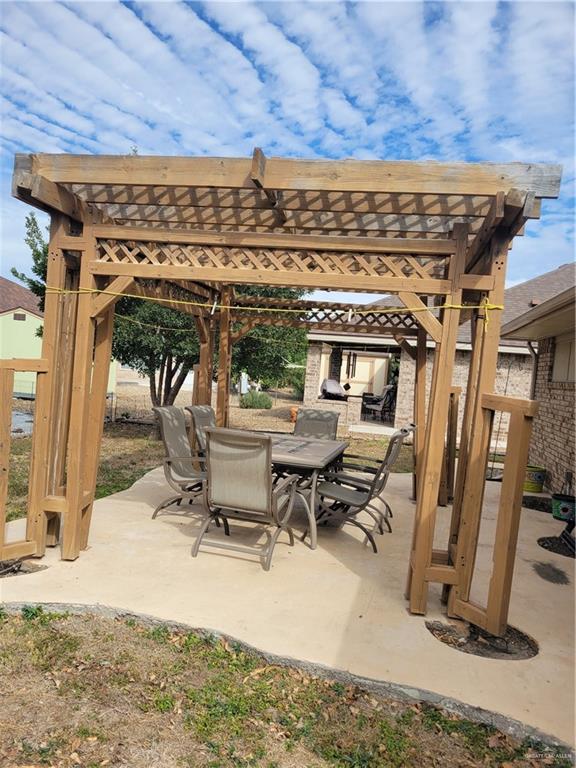 402 Jupiter Street Mission, TX 78572 - Photo 23 of 27 a view of a patio with a table and chairs