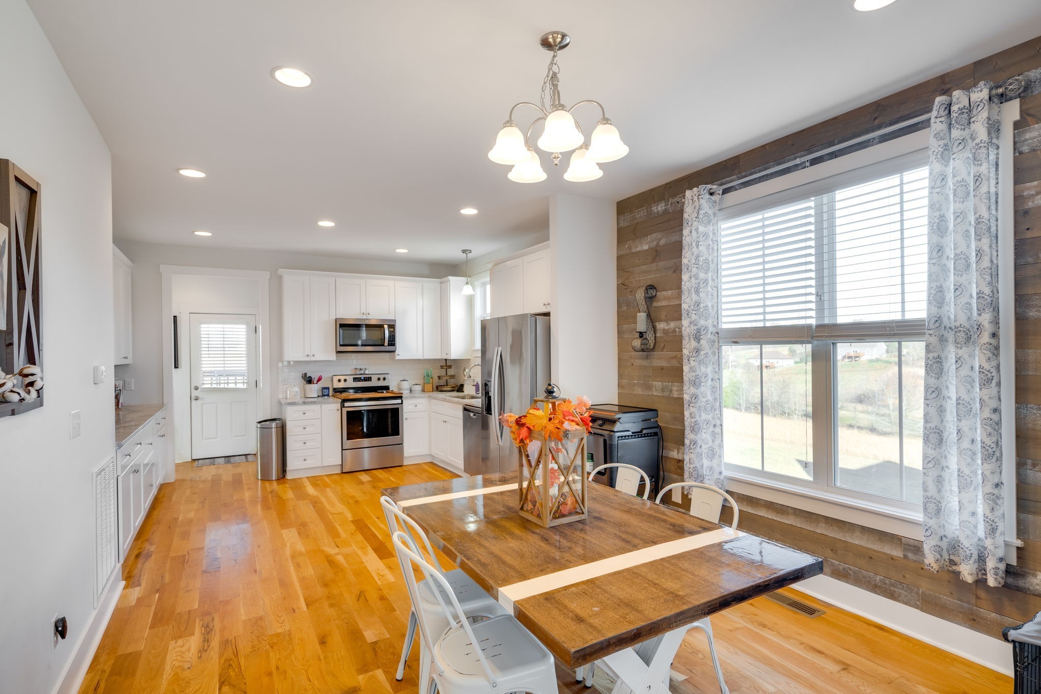 609 Womack Road Bethpage, TN 37022 - Photo 5 of 14 a living room with dining table wooden floor and a large window