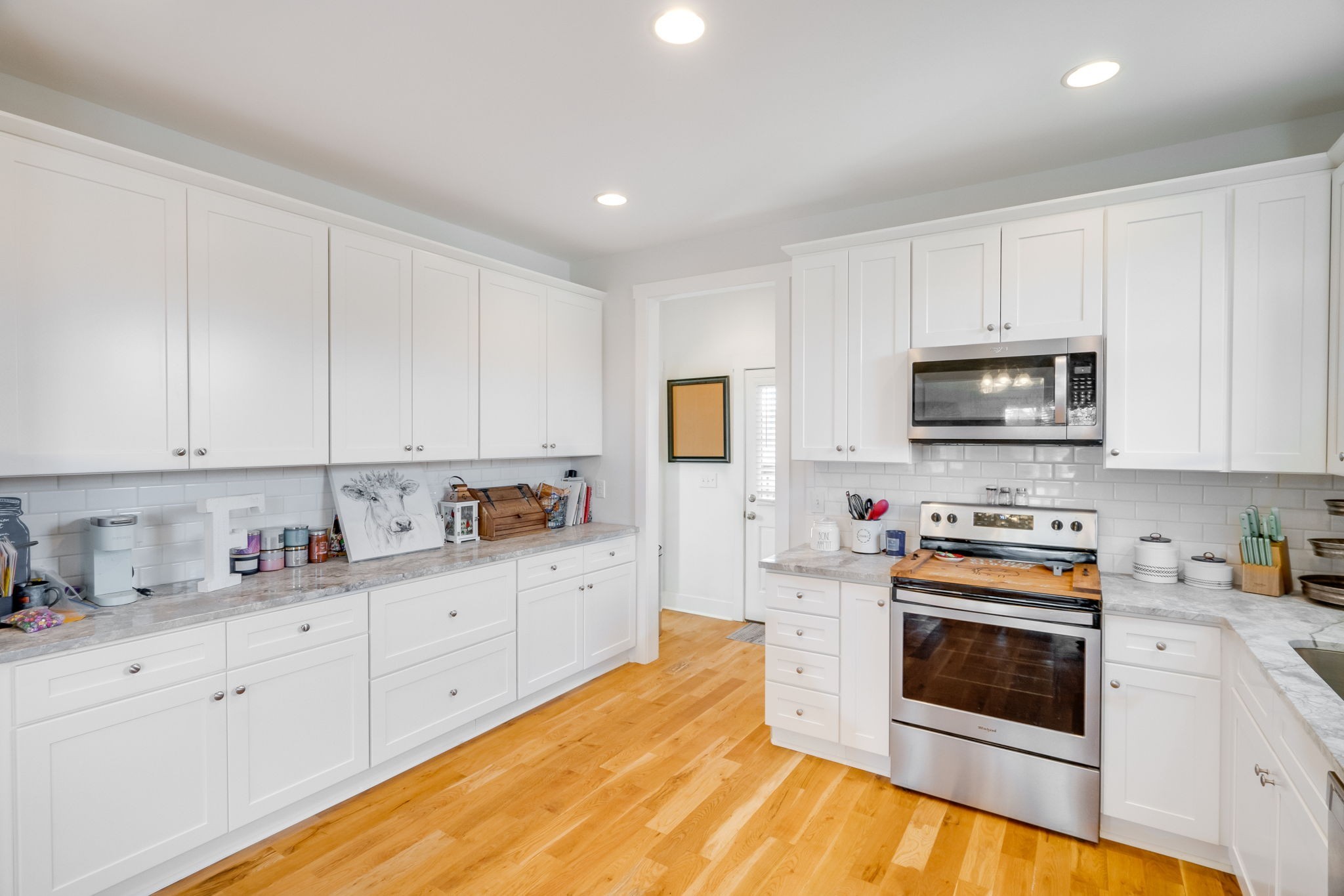 609 Womack Road Bethpage, TN 37022 - Photo 7 of 14 a kitchen with granite countertop white cabinets and white appliances