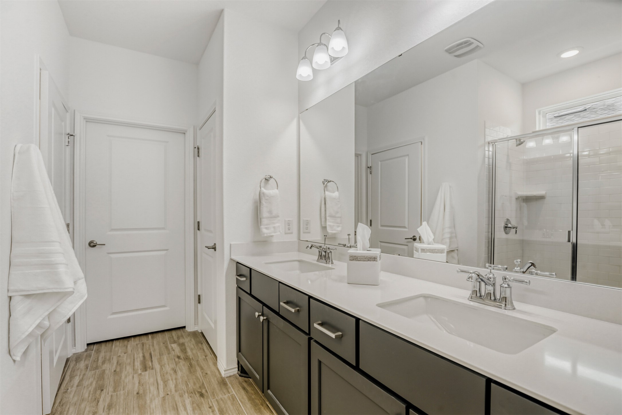 126 Clay Hl Street Georgetown, TX 78633 - Photo 13 of 20 Full bath with a shower stall, double vanity, and light wood finished floors