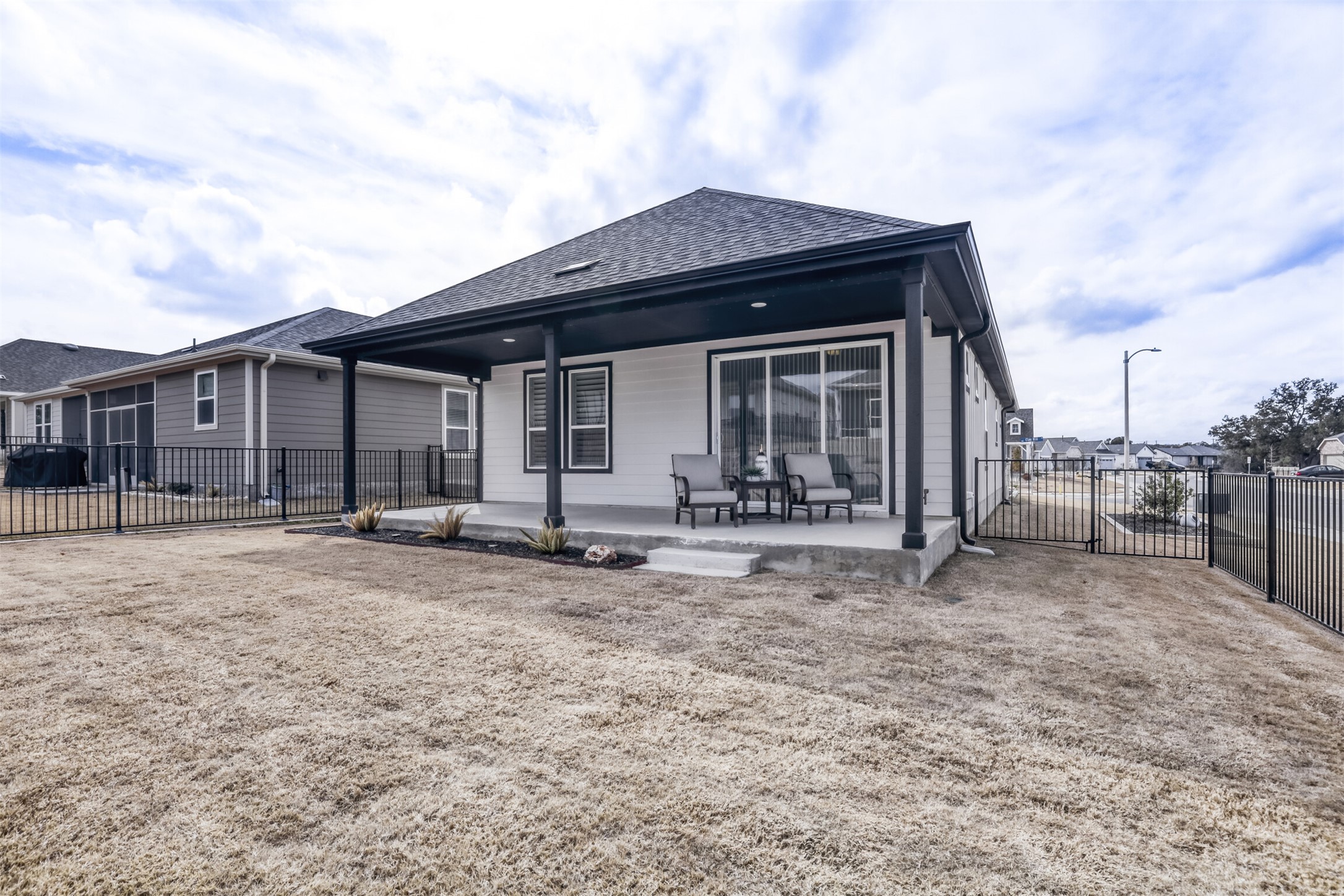 126 Clay Hl Street Georgetown, TX 78633 - Photo 20 of 20 Back of property featuring a gate, a patio area, and roof with shingles