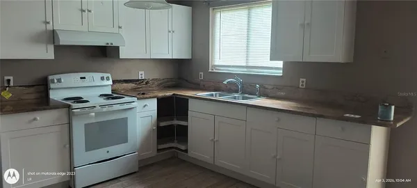 a kitchen with a sink stove and cabinets