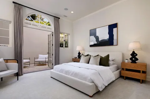 a bedroom with a bed and glass wall