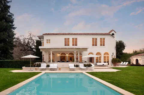 a view of a house with swimming pool yard and patio