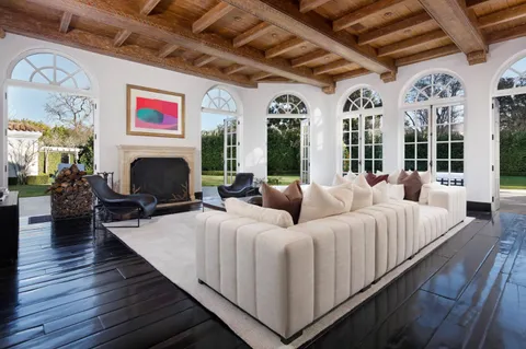 a living room with furniture windows and a fireplace