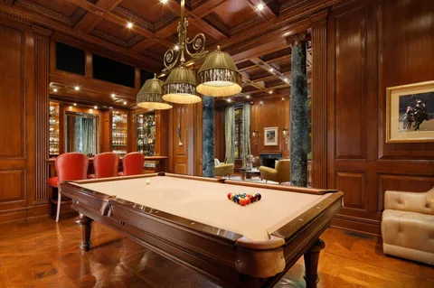 a room with pool table and a chandelier