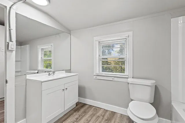 a bathroom with a toilet sink and mirror