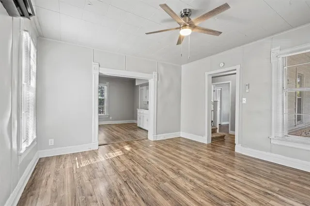 wooden floor in an empty room with a window