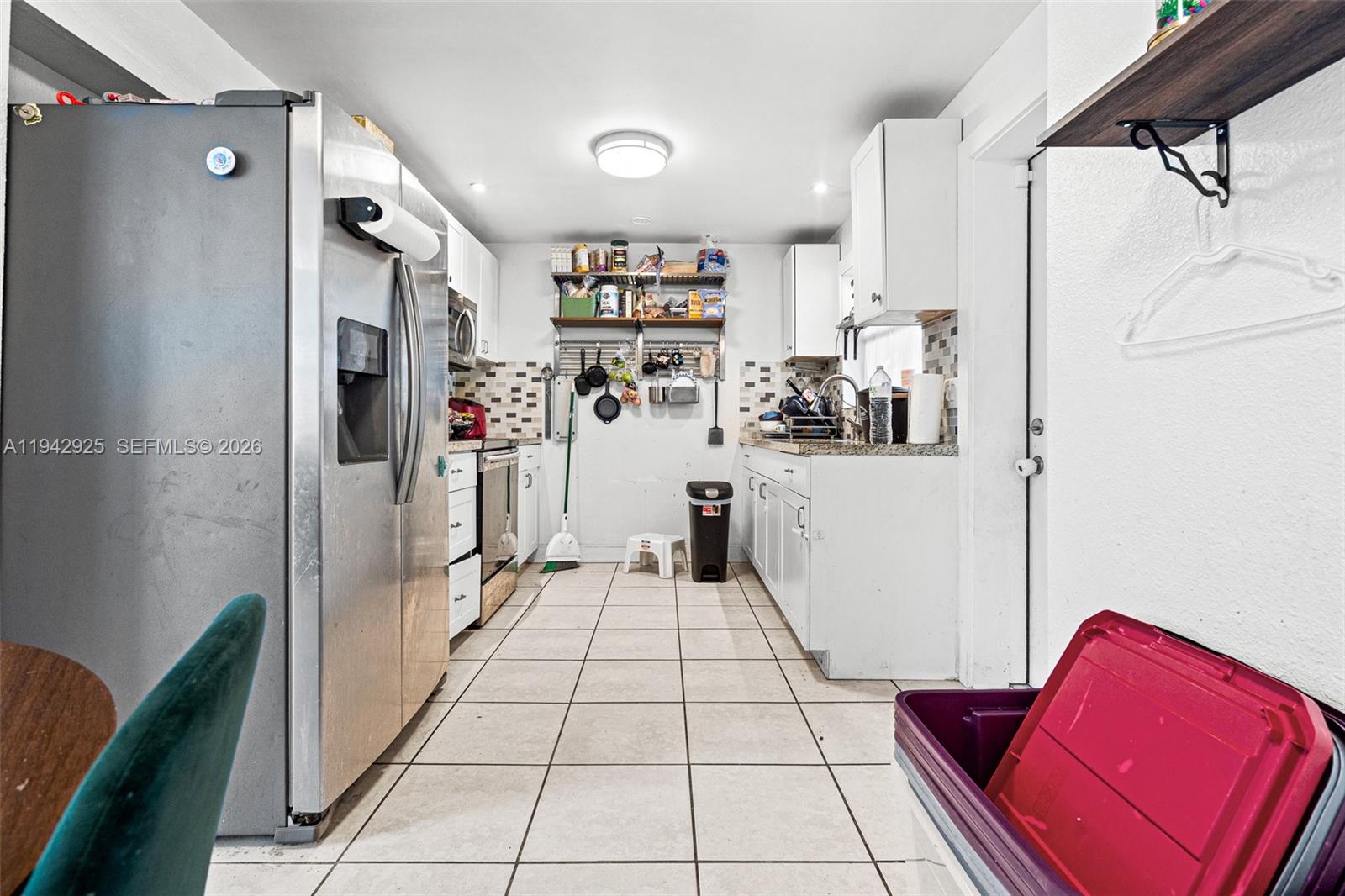 5844 Garfield Street Hollywood, FL 33021 - Photo 11 of 31 a view of a hallway with a refrigerator and a stove