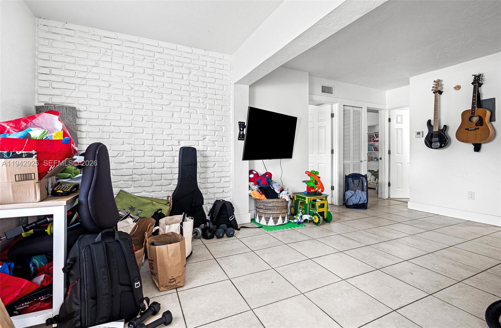 5844 Garfield Street Hollywood, FL 33021 - Photo 12 of 31 a view of a workspace with furniture and a flat screen tv