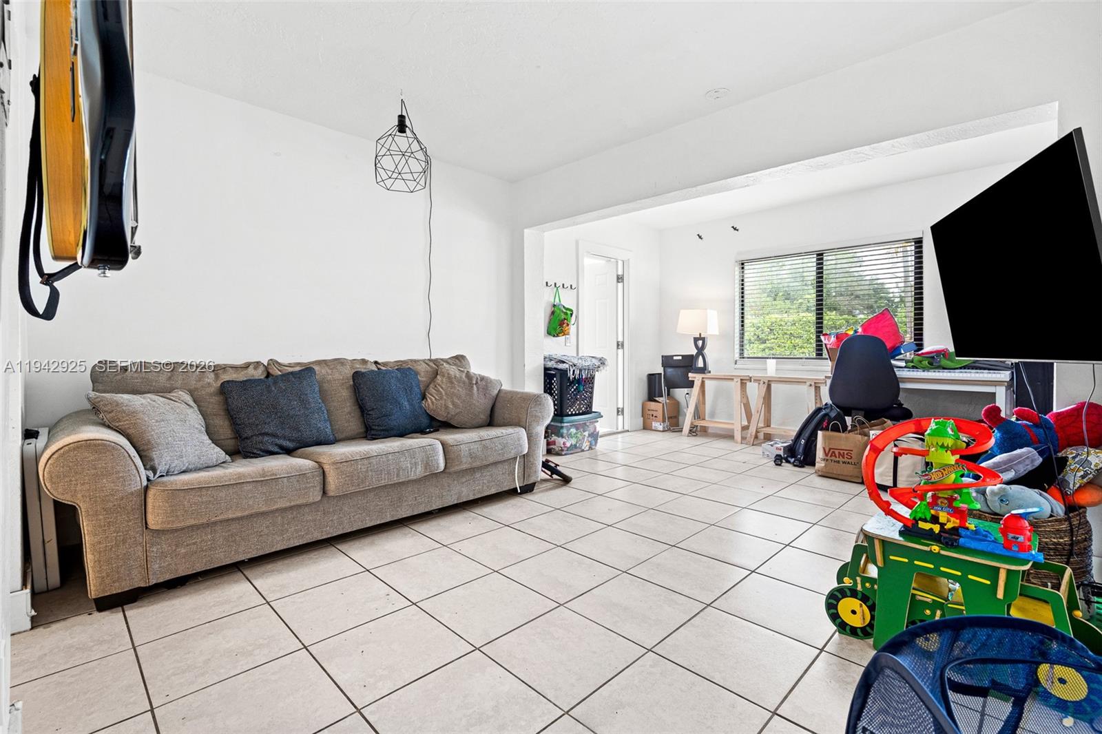 5844 Garfield Street Hollywood, FL 33021 - Photo 13 of 31 a living room with furniture and a flat screen tv