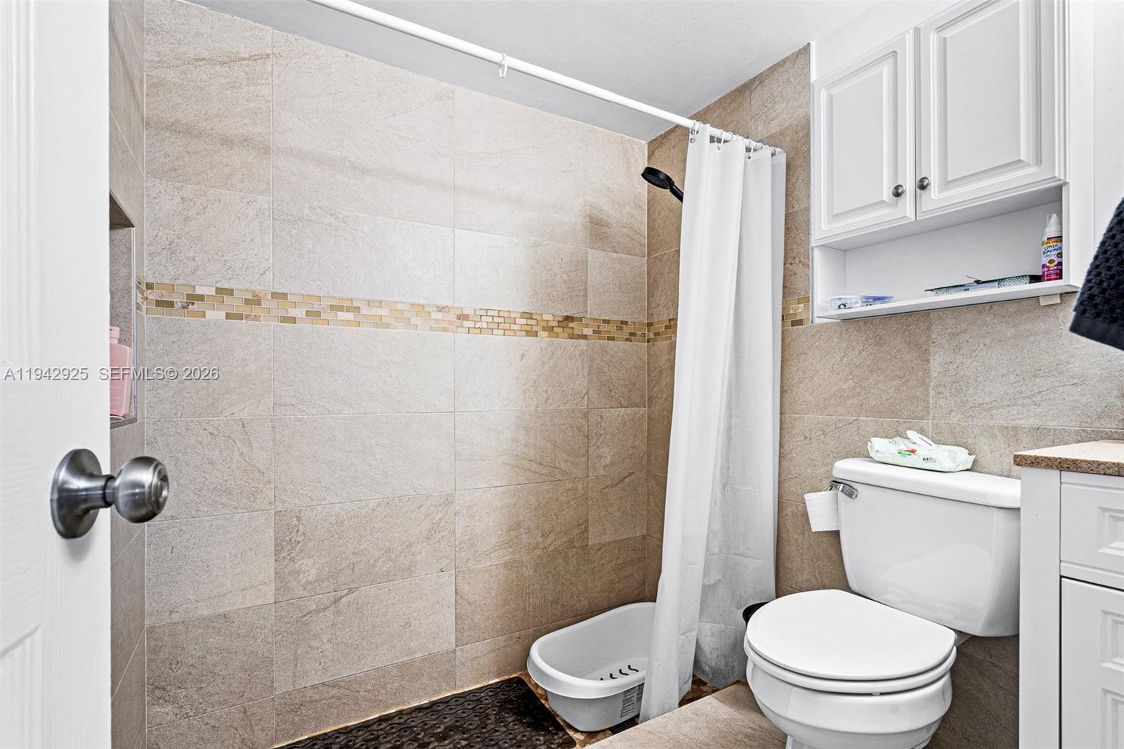 5844 Garfield Street Hollywood, FL 33021 - Photo 14 of 31 a white toilet sitting next to a shower