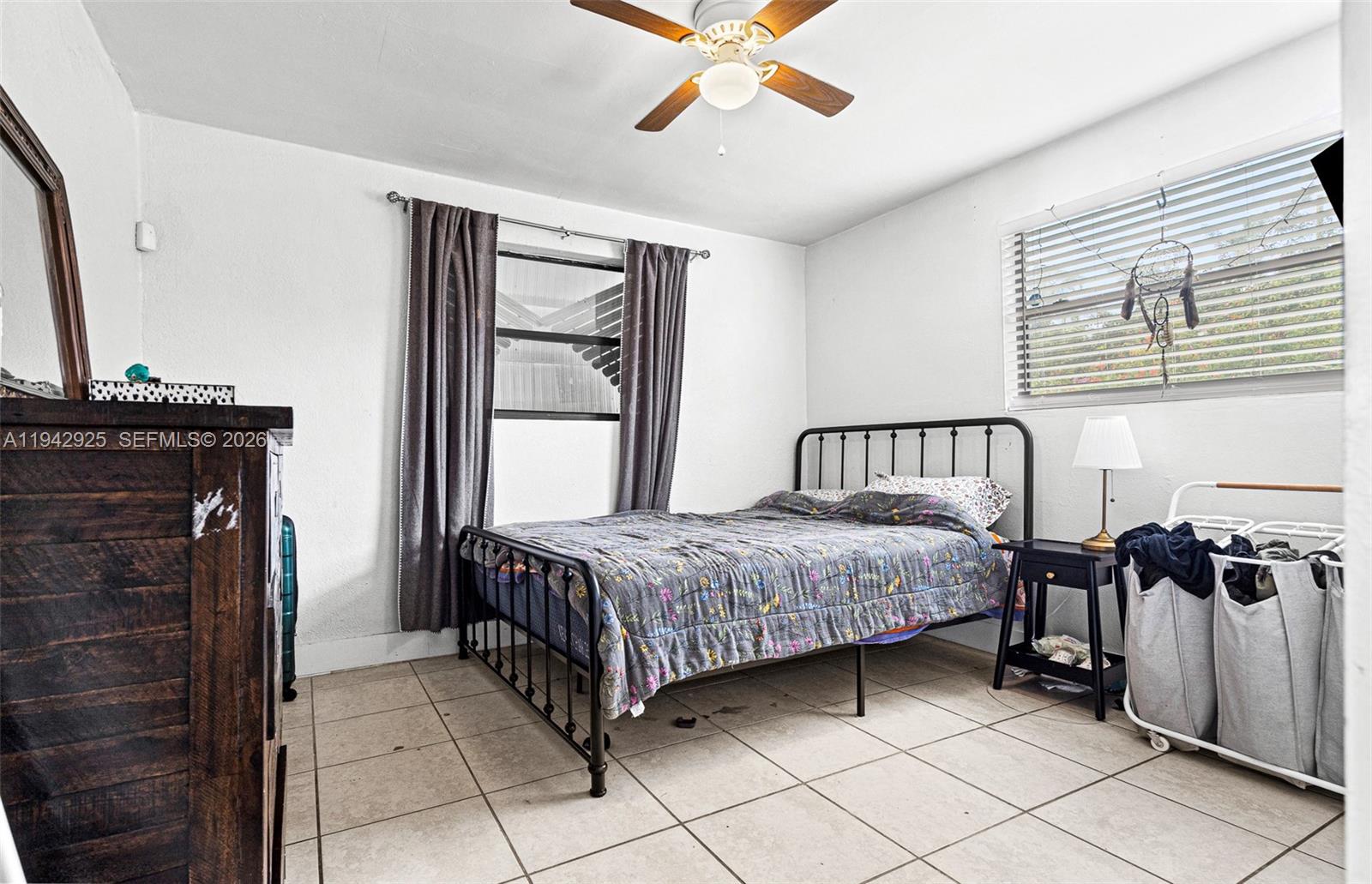 5844 Garfield Street Hollywood, FL 33021 - Photo 16 of 31 a bedroom with a bed next to a window with a flat screen tv